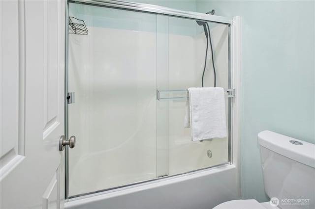 bathroom with enclosed tub / shower combo and toilet