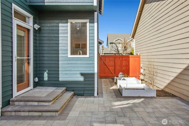 entrance to property with a patio and fence