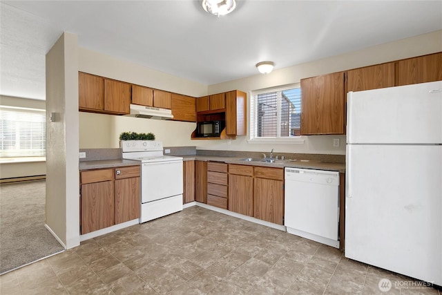 kitchen with white appliances, plenty of natural light, a sink, and under cabinet range hood