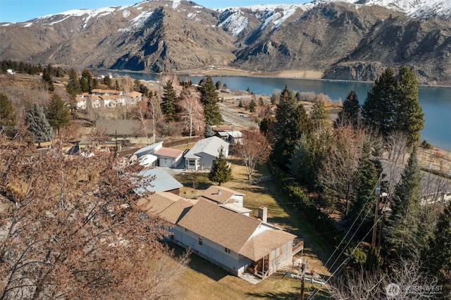 drone / aerial view featuring a water and mountain view