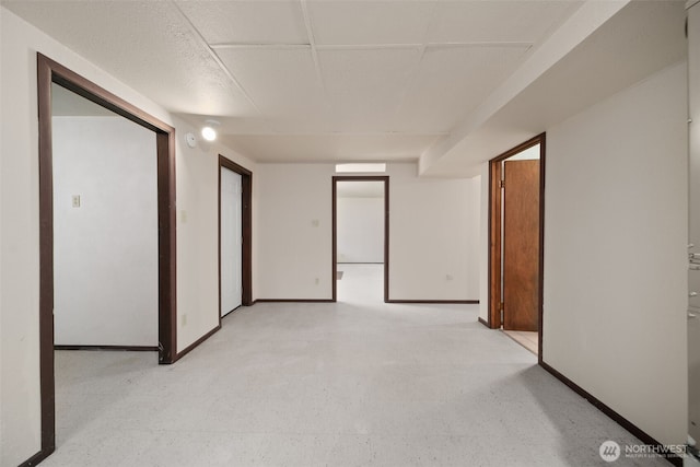 spare room with light floors and baseboards