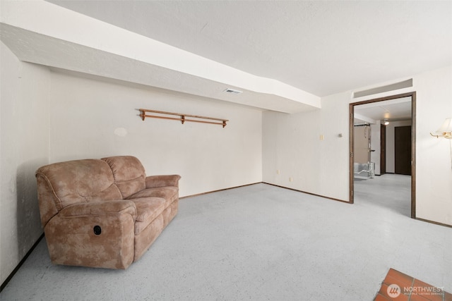 living area featuring visible vents and baseboards