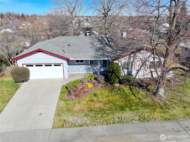 ranch-style home featuring driveway, stone siding, a shingled roof, an attached garage, and a front yard