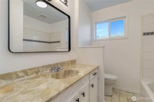 bathroom with vanity, toilet, baseboards, and visible vents