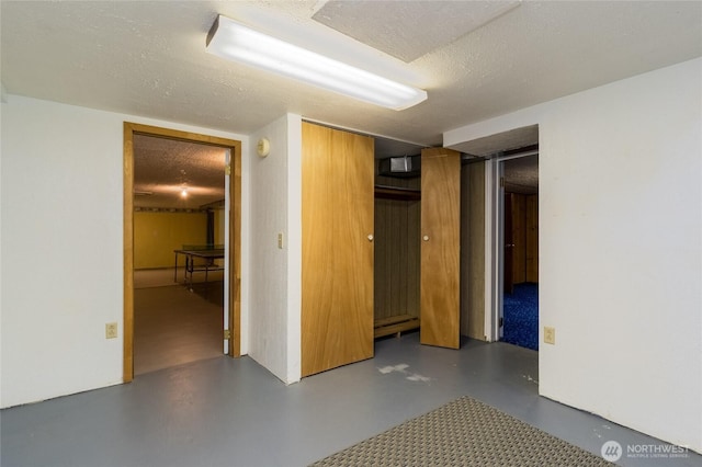 interior space featuring a closet, a textured ceiling, and concrete floors