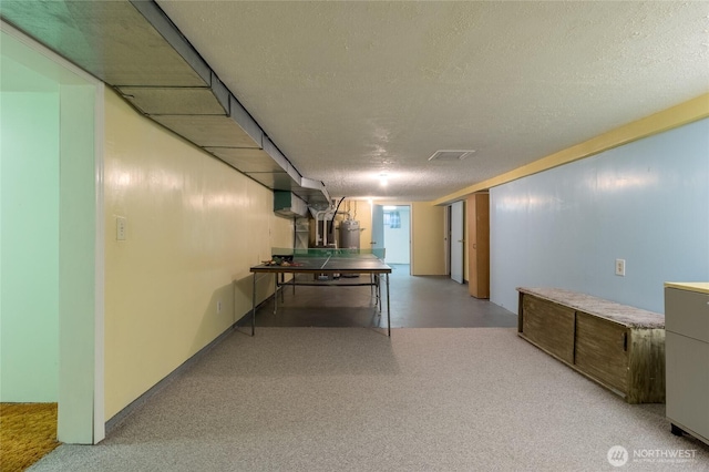 interior space featuring strapped water heater and a textured ceiling