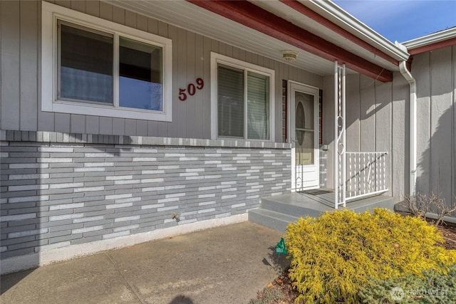 property entrance featuring brick siding