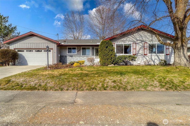 ranch-style home featuring a front yard, concrete driveway, and a garage