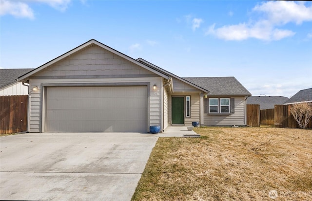 single story home with a front lawn, fence, driveway, and an attached garage