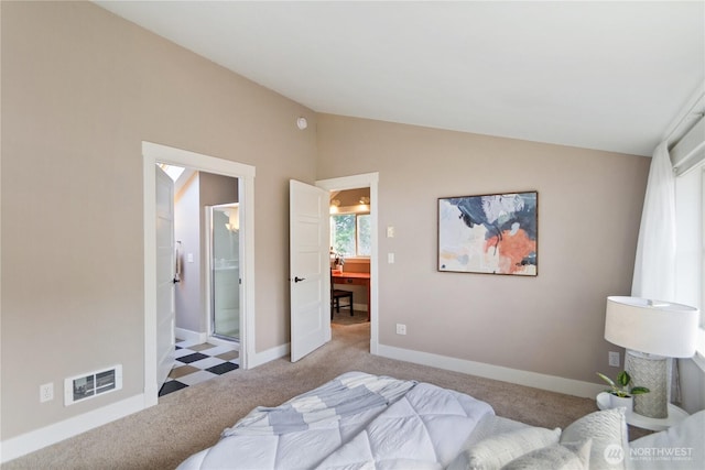 bedroom featuring visible vents, ensuite bathroom, baseboards, carpet flooring, and lofted ceiling