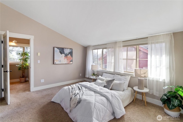 carpeted bedroom with multiple windows, baseboards, and lofted ceiling