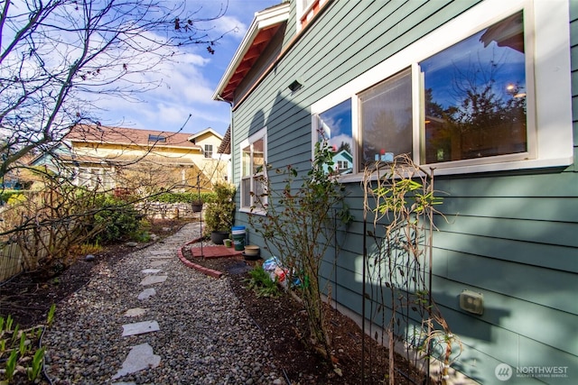 view of side of property featuring fence