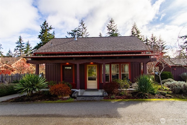 view of front of house with board and batten siding and a shingled roof