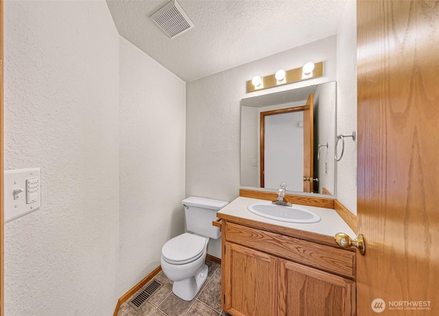 bathroom featuring tile patterned flooring, visible vents, toilet, and a textured ceiling