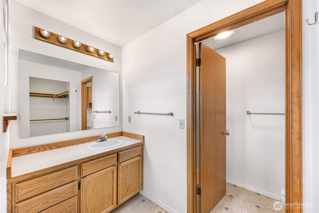 bathroom featuring baseboards and vanity