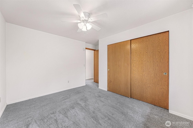 unfurnished bedroom featuring a closet, ceiling fan, baseboards, and carpet