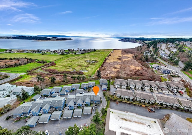 drone / aerial view with a water view and a residential view