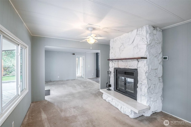 living room featuring visible vents, carpet floors, a fireplace, crown molding, and ceiling fan