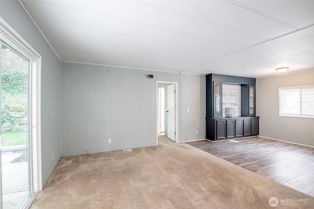 unfurnished living room featuring carpet