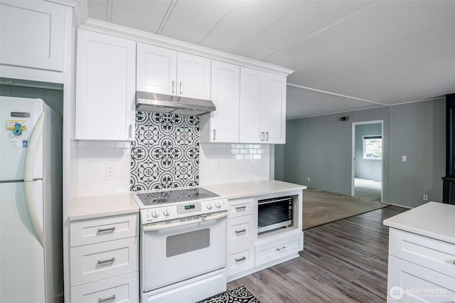 kitchen featuring white appliances, light countertops, and under cabinet range hood