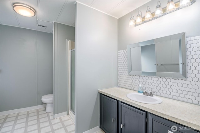 bathroom featuring tile patterned floors, decorative backsplash, toilet, and a stall shower