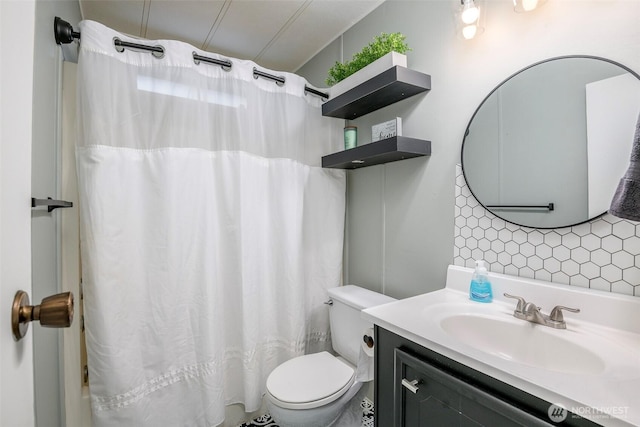 bathroom with vanity, toilet, and tasteful backsplash