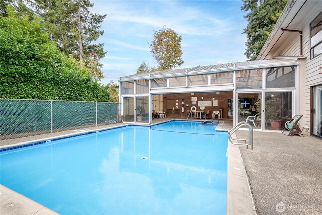 view of pool with a fenced in pool, a patio area, and fence