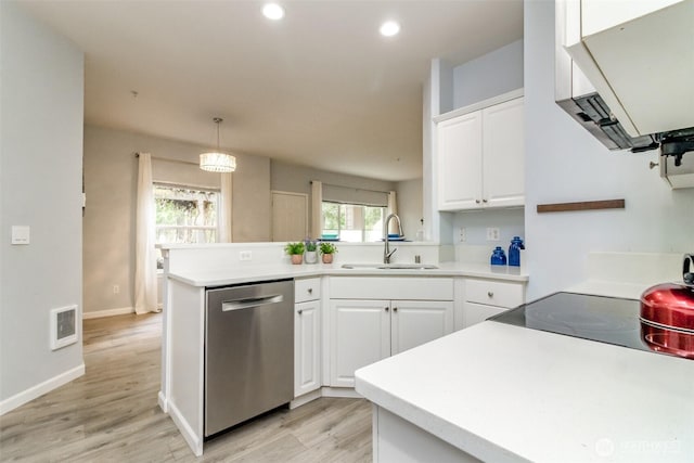 kitchen with visible vents, dishwasher, a peninsula, white cabinetry, and a sink