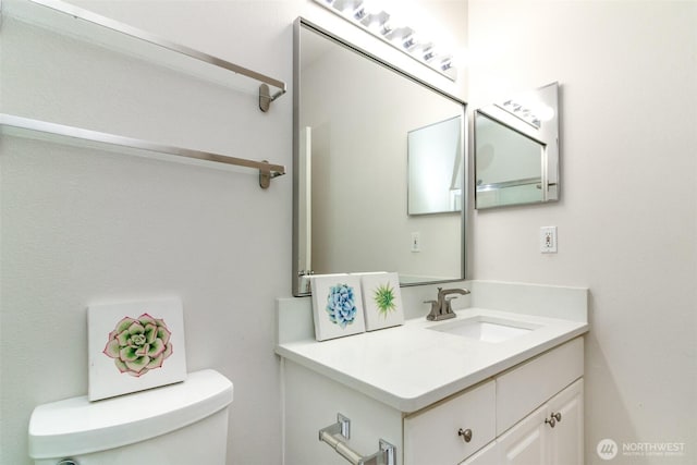 half bath featuring toilet and vanity