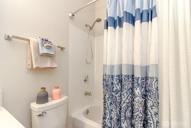 full bathroom featuring shower / bath combination with curtain and toilet