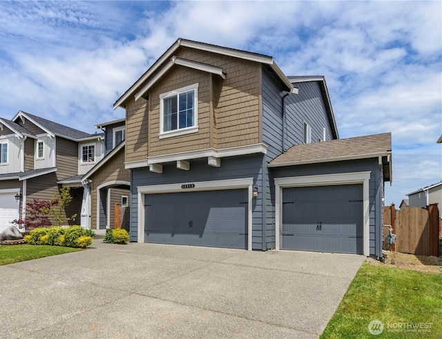 view of front of house featuring a garage, fence, and concrete driveway