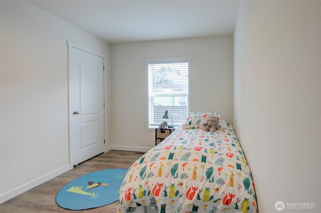 bedroom featuring wood finished floors and baseboards