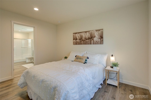 bedroom featuring baseboards, ensuite bathroom, wood finished floors, and recessed lighting