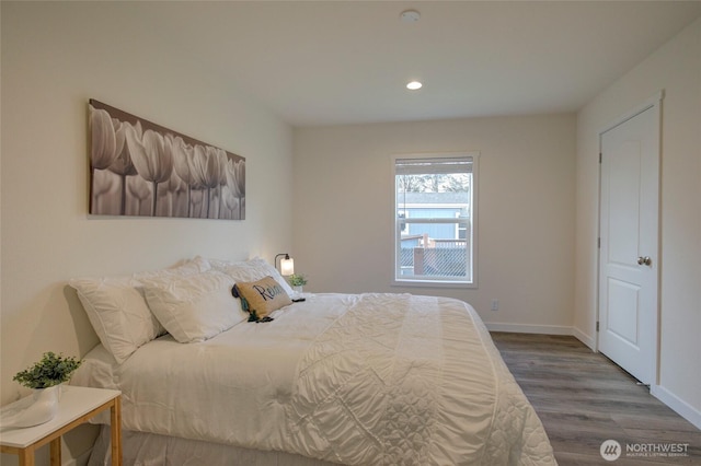 bedroom featuring recessed lighting, wood finished floors, and baseboards