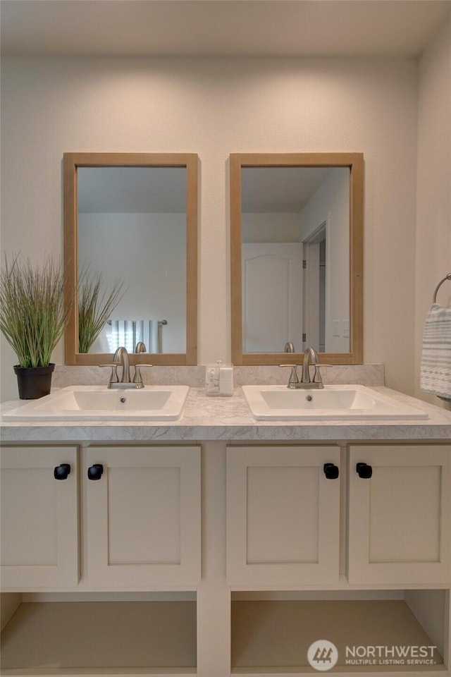 bathroom with double vanity and a sink