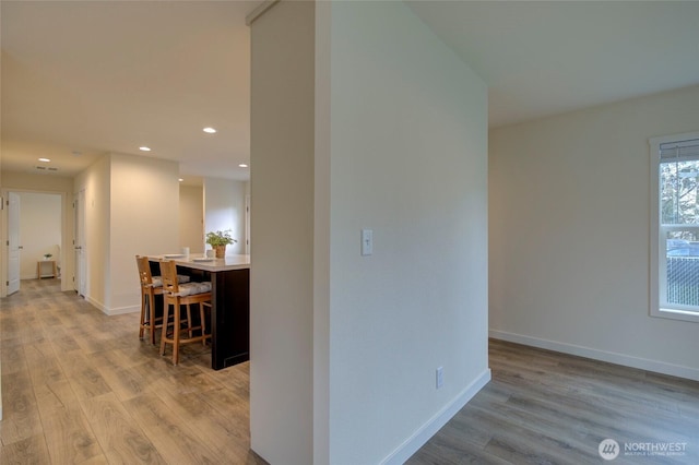 interior space featuring light wood-type flooring, baseboards, and recessed lighting