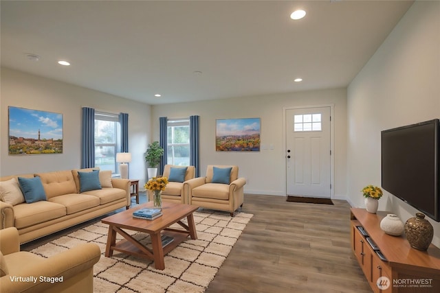 living room with light wood finished floors, baseboards, and recessed lighting