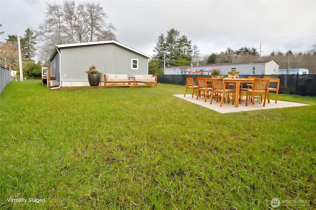 view of yard featuring fence private yard, a patio, and an outdoor hangout area