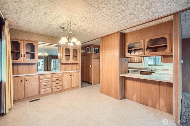 3222 S 183rd St, Seatac, WA 98188 - kitchen with visible vents, glass insert cabinets, light countertops, and a notable chandelier