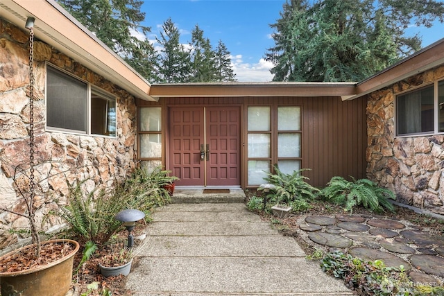 entrance to property featuring stone siding