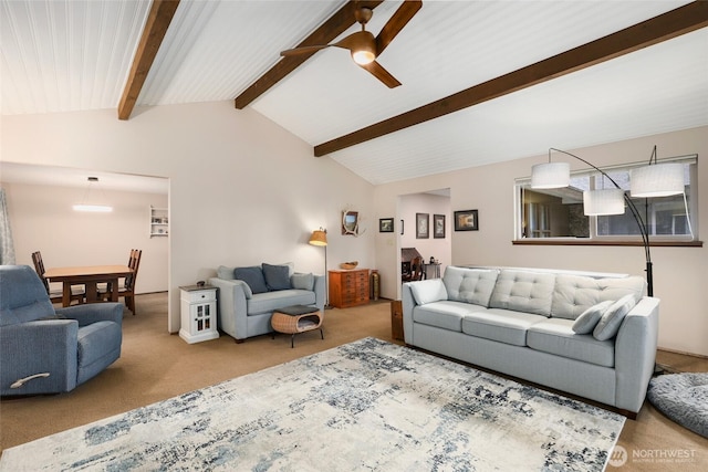 living room featuring lofted ceiling with beams, ceiling fan, and carpet floors