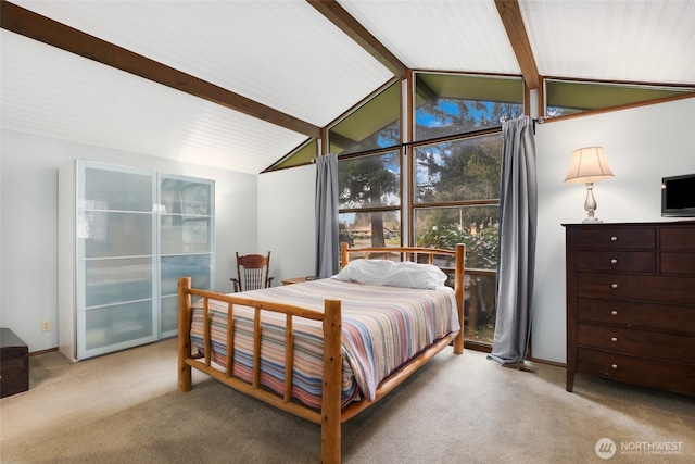 bedroom with lofted ceiling with beams and carpet floors