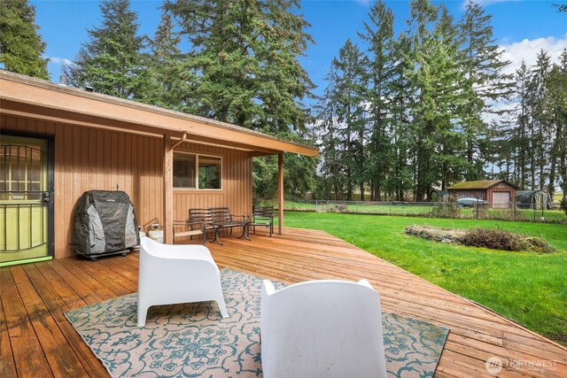 wooden deck featuring a yard, area for grilling, and fence