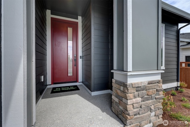 property entrance featuring stone siding