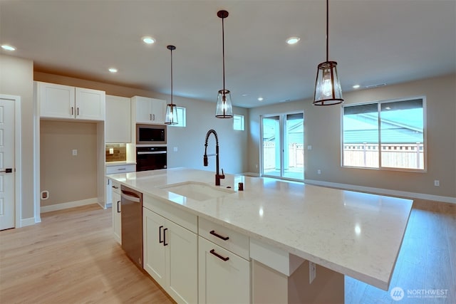 20907 150th St E Unit 1460, Bonney Lake, WA 98391 - kitchen featuring recessed lighting, a sink, white cabinets, appliances with stainless steel finishes, and light wood finished floors