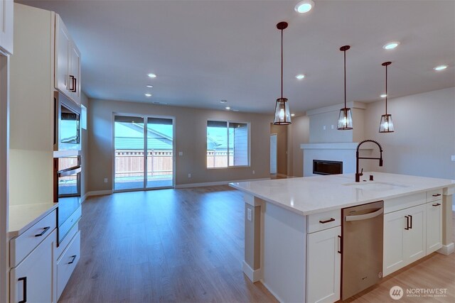 20907 150th St E Unit 1460, Bonney Lake, WA 98391 - kitchen with light wood finished floors, stainless steel appliances, recessed lighting, open floor plan, and a sink