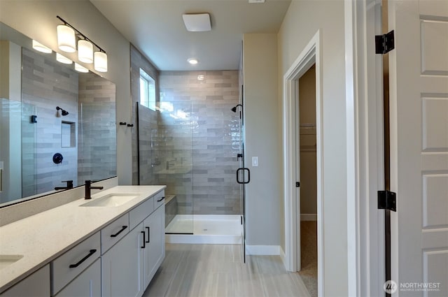 20907 150th St E Unit 1460, Bonney Lake, WA 98391 - bathroom featuring a sink, baseboards, a spacious closet, a shower stall, and double vanity