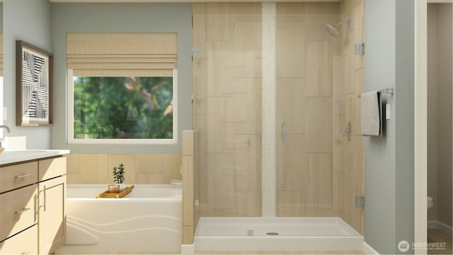 bathroom with a garden tub, a shower stall, and vanity