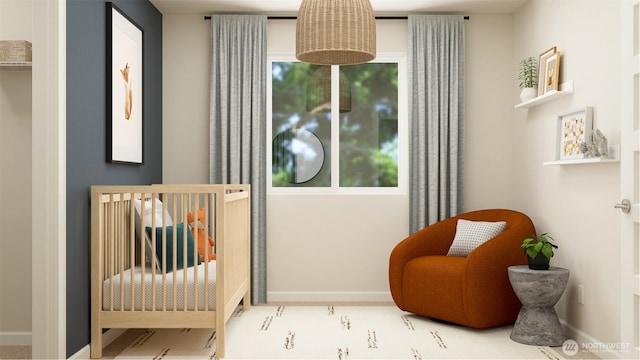 bedroom featuring a nursery area and baseboards