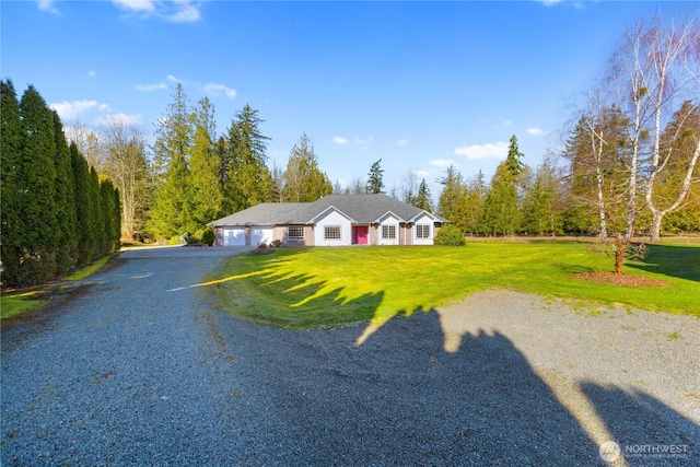 view of front of house featuring a garage and a front yard